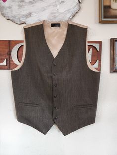 "Vintage Men's Vest  *  6 Button Vest  *  2 Front Pockets *  Worsted Wool and Poly Blend - Front *  Lining and Back Acetate *  JF - J. Ferrar - Custom Fit Suits *  Brown and Gold  No Label Size - See Actual Measurements Below 44\"  chest 42\"  Mid Section  23\" to 26\" Length (Side and Front Tips) Vintage Western Shirt  *  Short Sleeves *  Pearlized Snaps *  Two Front Pockets with Snaps *  Striped - Gray With Green Burgundy and Black Stripes *  Rounded Hem  *  Label:  Plains Western Wear - Label Size M *  Fabric Label is Faded - Feels Like Cotton Poly Blend Actual Measurements of Shirt: 46\"  Chest  18\"  Shoulders 44\"  Mid Section - Waist Area 28\" to 30\" Length  Remember you need to fit within the measurements given for the best fit, keeping into consideration decade/style and fit of a Wool Business Vest With Button Closure, Formal Wool Vest With Button Closure, Classic Wool Vest With Button Closure, Tailored Brown Vest With Button Closure, Classic Tailored Vest With Buttons, Classic Semi-formal Vest With Button Closure, Brown Buttoned Vest For Formal Occasions, Brown Formal Vest With Buttons, Formal Brown Vest With Buttons