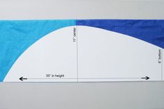 a piece of blue and white paper with an arrow pointing to the right