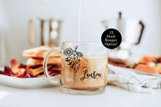 a glass mug filled with liquid sitting on top of a table