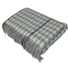 a blue and white checkered blanket with fringes