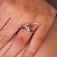 a woman's hand with a diamond ring on her finger and the words oost above it