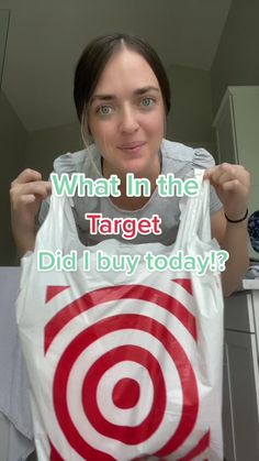 a woman holding up a bag with the words what in the target did i buy today?