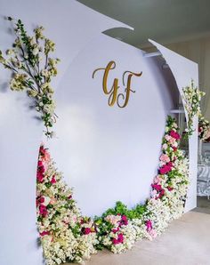 a white sign with flowers on it and the letter gf in gold foil lettering