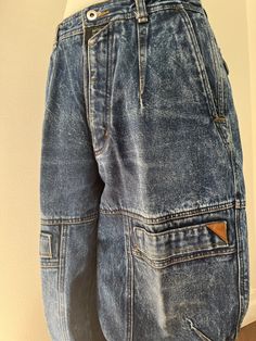 A gorgeous dark acid wash denim Bugle Boys with so many cool details!  So many pockets, seams and darts!  Tapered leg. 100% cotton Excellent condition! No size label.  Measurements: 20" waist, 12" rise, 33" inseam, 27" thigh, 7" leg opening. Distressed Denim Blue Grunge Cargo Jeans, Distressed Denim Blue Cargo Jeans In Grunge Style, Pre-washed Recycled Denim Blue Bottoms, Pre-washed Recycled Denim Blue Jeans, Distressed Dark Wash Recycled Denim Cargo Jeans, Washed Rigid Denim Cargo Jeans In Denim Blue, Distressed Recycled Denim Cargo Jeans In Dark Wash, Washed Denim Blue Cargo Jeans, Vintage Denim Blue Cargo Jeans For Streetwear