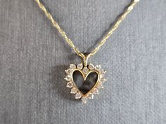 A WOMEN'S VINTAGE ESTATE  14K GOLD FINE NECKLACE AND 14K GOLD HEART PENDANT WITH DIAMONDS.  NECKLACE MEASURES 18" LONG.  HEART PENDANT IS 14K GOLD AND MEASURES 5/8" LONG BY 1/2" WIDE. TOTAL WEIGHT OF ITEM IS 2.4g.  WOULD MAKE A LOVELY GIFT FOR THAT SOMEONE SPECIAL.   ANY QUESTIONS, PLEASE ASK.  BE SURE TO CHECK OUT SOME OF MY OTHER GREAT ITEMS UP FOR SALE. THANK YOU Gold Heart Necklace Stamped 14k For Wedding, Classic Gold Heart Cut Diamond Necklace, Heirloom Gold Necklace With Hallmark, Gold Heart Cut Diamond Necklace For Formal Occasions, Vintage Yellow Gold Necklace With Diamond Accents, Fine Jewelry Wedding Necklace With Hallmark, Vintage White Gold Necklaces For Valentine's Day, Vintage Yellow Gold Necklace For Anniversary, Gold Heart-shaped Diamond Necklace For Weddings