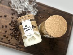 an iced coffee candle next to some beans