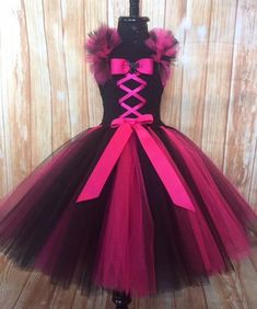 a dress with pink and black ribbons on it