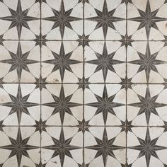 an old tile floor with star designs on it