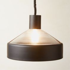 a light hanging from a ceiling fixture with a cord attached to the top of it