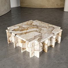 a marble coffee table sitting on top of a cement floor