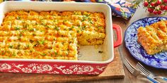 a casserole dish with meat and vegetables in it on a wooden cutting board