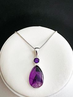 "GENUINE AMETHYST PENDANT Natural Amethyst Necklace, February Birthstone Jewelry NECKLACE FEATURES: Metal: All components are made from solid .925 Sterling Silver Model is wearing 16\" in length solid .925 Sterling Silver Chain Length available: 16\", 18\" or 20\" Measurement: Sterling Silver Natural Amethyst Pendant Height: 45 mm Width: 20 mm Please send me a message if you have any questions before or after placing your order. Please also view my policy before purchasing. Please visit my store Purple Gemstone Necklace For Wedding, Amethyst Necklace With Gemstone Accents For Wedding, Purple Teardrop Necklace For Wedding, Amethyst Necklaces For Wedding, Teardrop Amethyst Stone Jewelry, Amethyst Birthstone Necklace For Wedding, Wedding Amethyst Birthstone Necklace, Teardrop Amethyst Necklaces With Gemstone Accents, Purple Teardrop Pendant Necklace For Anniversary