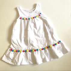 Baby Guess Infant Girls Birthday Dress 18 Months Solid White Colorful Pom Poms Item Details: 100% Cotton Machine Wash Cold Button Opening At The Back Tiered Skirt Imported Approximate Measurements Laid Flat: Armpit To Armpit: 11" Top Of Shoulder To Hem: 17.5" White Cotton Dress For Birthday, Cotton Sleeveless Dress For First Birthday, White Sleeveless First Birthday Dress, White Sleeveless Dress For First Birthday, White Sleeveless Dress For Playtime, White Sleeveless Playwear Dress, Playful White Playwear Dress, Playful White Cotton Dress, White Summer Playwear Dress