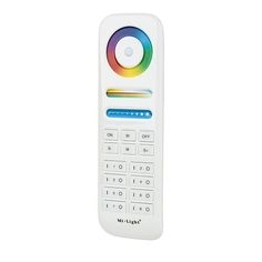 a white remote control with multicolored buttons on it's front side and back end