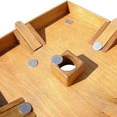 a close up of a wooden table with holes in the center and two pieces of wood on top