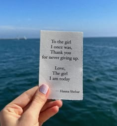 someone holding up a piece of paper with the quote to the girl i once was, thank you for never giving up