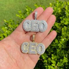 "Solid 925 sterling silver CEO pendant Be the Boss and wear this piece!! Super Iced out and very detailed. 3D effect 2\" wide...1\" tall (1.5\" w bale) Weighs about 26.5 grams Solid 925 sterling silver in either Rhodium Finish or 14k gold vermeil (two tone with silver letters) Iced with 4.5ct simulated diamonds (cz)...nice mix of natural & round stones Pendant only. Chains sold separately." Anniversary Cubic Zirconia Nameplate Jewelry, Classic Diamond Nameplate Jewelry, Yellow Gold Nameplate Jewelry With Diamond Accents, Engraved Diamond Nameplate Jewelry, Silver 14k Gold Necklace With Diamond Accents, 14k Gold Silver Necklace With Diamond Accents, Luxury Engraved Diamond White Jewelry, White 14k Gold Nameplate Jewelry, Silver Cubic Zirconia Nameplate Jewelry