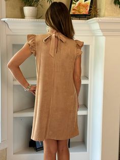 Embrace elegance with our Suede Ruffle Sleeve Dress in Taupe. This chic and sophisticated dress will be your new fall favorite. Whether you're heading to a special event or a casual outing, this dress is up to the job. Pair it with your favorite boots or booties for a complete look. DETAILS Faux Suede Fabric: Soft and luxurious feel in a beautiful taupe color. Ruffle Sleeves: Add a touch of femininity and flair. High Neck Band with Slight Ruffle: Enhances the elegant and refined look. Keyhole an Faux Suede Fabric, Ruffle Sleeve Dress, Favorite Boots, Sophisticated Dress, Suede Fabric, Fall Favorites, Taupe Color, Dress Jewelry, Ruffle Sleeves