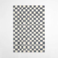 a black and white checkered rug on a wall