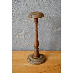 an old wooden candle holder on a table