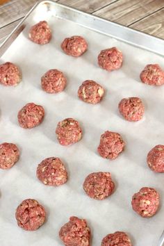 raw meatballs on a baking sheet ready to go into the oven or freezer