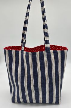 Sophisticated Blue Stripe shopping bag with red polka dot lining for a bit of flash.  Lining can vary...let me know if you prefer another lining. ALSO AVAILABLE IN GREEN STRIPE. * 100% Cotton Fabric and Fully Lined. * Approximate Size: 16" W x 16" H with 4" boxed bottom. * Handmade in California on my vintage ELNA sewing machine, in a smoke-free, pet-free home. * Reusable & Eco-Friendly. * Perfect bag to use for light shopping, knitting bag project bag, beach day, purse or to give as a gift! Reversible Bucket Bag For Shopping, Shopping Bag With Striped Lining And Double Handle, Everyday Bags With Striped Lining And Double Handle, Everyday Tote Shoulder Bag With Striped Lining, Daily Use Shoulder Bag With Striped Lining, Rectangular Bags With Striped Lining For Daily Use, Tote Bags With Striped Lining For Everyday Use, Tote Shoulder Bag With Striped Lining, Daily Use Tote Shoulder Bag With Striped Lining