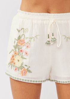 A classic bohemian cotton short with contrast floral embroidered detail. Embroidered Relaxed fit Side pockets Drawstring waist Smocked elastic waist Bohemian shorts Dry clean recommended or hand wash cold Get resort ready in our ultra-relaxed boho shorts, the ultimate vacation essential! Crafted from soft cotton gauze and adorned with intricate floral embroidery, these shorts feature a smocked elastic waist for the perfect fit and essential side pockets. Whether you’re lounging by the pool or en Bohemian Shorts, Layered Sweater, Embroidered Shorts, Tank Top Camisole, Office Casual, Embroidered Top, Cotton Shorts, Boho Shorts, Floral Embroidery