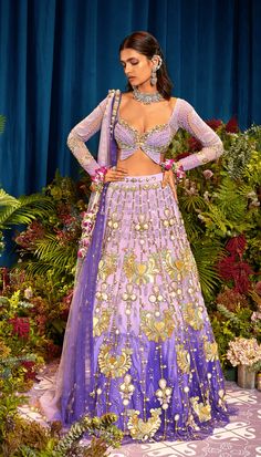 Step into a world of enchantment with our Shaded LILAC Tulle Lehenga Set - a spellbinding fusion of colors and textures. Watch as custom cut acrylic pieces, gold metal embellishments, and rich fabric appliques come together to create a truly mesmerizing design. Paired with our signature butterfly full-sleeved blouse in lilac silks, and a delicately embroidered tulle dupatta that glistens with metals, pearls, and sequins. Get ready to dazzle and make a statement on your special day!" Colour: Ligh Ombre Lehenga, Tulle Lehenga, Papa Don't Preach, Lilac Blouse, Dark Ombre, Ombre Fabric, Metal Embellishments, Butterfly Blouse, Gold Embellishment