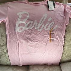 Brand New Tee Shirt With Barbie Going Around The Front. It’s Light Pink. Tags Are On And No Issues Shirt Color, Pink White, Tee Shirt, Light Pink, Colorful Shirts, Tee Shirts, Womens Tops, Tops & Tees, Brand New