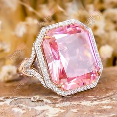 Specification:-  *Diamond Material : Cubic Zirconia  *Center Diamond Shape : Radiant  *Center Diamond Measurement : 18*16 MM *Side Diamond Measurement : 1.00, 1.20, 1.40, 1.20, 1.40 MM *Side Diamond Weight : 1.42 CT  *Diamond Color : White & Pink *Diamond Clarity : VVS *Making Process: Handmade by our Experienced Staff. *Stamp: Our All Rings Stamped According to metal Purity (925 SIL/10K/14K/18K). Custom Order:- *We do Accept Custom order. *Buyer can also request customization in listed Items (C Pink Diamond Ring With Diamond Accents For Wedding, Pink Diamond Ring With Accents For Wedding, Pink Diamond Ring With Halo Setting For Wedding, Pink Cubic Zirconia Halo Ring For Wedding, Pink Diamond Topaz Ring For Wedding, Fine Jewelry Pink Topaz Wedding Ring, Emerald-cut Rose Gold Topaz Ring For Wedding, Pink Topaz Wedding Ring With Diamonds, Emerald Cut Rose Gold Topaz Ring For Wedding