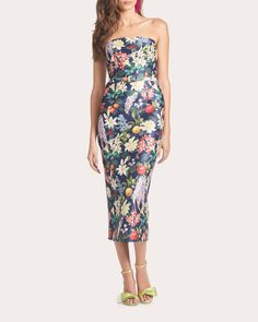 Bouquets of fruits and florals pop against the navy mikado canvas of the Fiore dress, a striking strapless midi. Belted at the waist, the silhouette fits slim throughout the hips and thighs to create a column-like shape. Zip closure Strapless neckline Belted waistline Darted bodice seams Vented back hem Mikado 84% polyester, 12% nylon, 4% spandex Dry clean only Materials sourced from China Made in India Size & Fit Garment measurements (size US 4): 47in long from center back neckline to hem Model Flora Dress, Evening Tops, Strapless Neckline, Large Clothes, Cocktail Attire, Gowns With Sleeves, Beauty Clothes, Sweaters Knitwear, Evening Wear