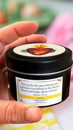 a hand holding a jar of honey with a quote on the label in front of it