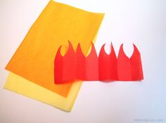 three red and yellow pieces of paper on top of each other with one piece cut out