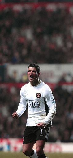 a soccer player with his mouth wide open in front of an audience at a sporting event