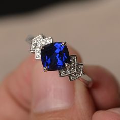 This is a gorgeous handmade creation. Its beauty is its simplicity & Elegance. The 7*7 mm cushion shape faceted lab sapphire is crafted in solid sterling silver and with rhodium plated. All item is sent in a beautiful gift box If you have any idea of design your ring,pls contact me directly. You can realize more lovely stuff clicking the link https://www.etsy.com/shop/knightjewelry?refshopsection_shophome_leftnav Please leave the correct address and you phone number for delivering successful Adjustable Sapphire Ring Fine Jewelry, Adjustable Sapphire Ring In Fine Jewelry Style, Cushion Cut Sapphire Ring Gift, Elegant Blue Square-cut Rings With Diamond Cut, Elegant Blue Square Cut Diamond Rings, Sapphire Rings With Diamond Cushion Cut, Sapphire Ring With Square Diamond Cut, Cushion Cut Sapphire Ring With Cubic Zirconia Accent Stones, Square Cut Blue Diamond Ring