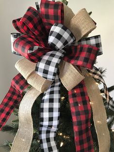 a christmas tree with a red and black plaid bow