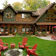 an outside view of a house with lawn chairs and fire pit