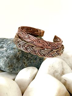 "Discover our beautiful and unique Handmade Pure Copper Bracelet from Nepal 🌍✨Crafted with love by skilled Nepali artisans whom we work closely with to bring our vision to life, these timeless accessories are simple yet exquisite. Add a touch of charm to your wrist with this special copper bracelet, carefully crafted by talented artisans in Kathmandu Nepal. The beautiful detailing and warm copper tones make it a timeless accessory that goes with any outfit. Wear a piece of Nepal's craftsmanship and culture - a simple yet stylish statement for any occasion. 🧡🌟\" #1 Copper - Size: 18cm Width - 10mm Weight - 25 gms  #2 Three Metal - Size: 20cm Width - 12mm Weight - 25 gms  Benefits of Wearing Copper Bracelets: Copper bracelets are believed to offer various potential benefits, including ant Handmade Spiritual Braided Bangle Bracelet, Artisan Friendship Bracelet Jewelry, Artisan Friendship Bracelet, Artisan Adjustable Bangle Bracelets, Handmade Adjustable Artisan Bangle, Adjustable Artisan Bangle Cuff Bracelet, Adjustable Artisan Bracelet As Gift, Artisan Adjustable Bracelet As A Gift, Artisan Adjustable Bracelet As Gift