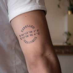 a man with a tattoo on his arm that reads exhaled and contains numbers