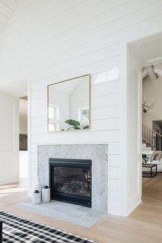 a living room with a fireplace and white walls