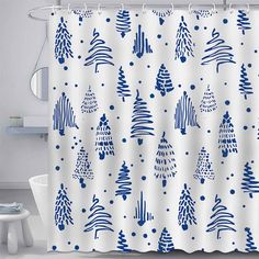 a white shower curtain with blue christmas trees on it