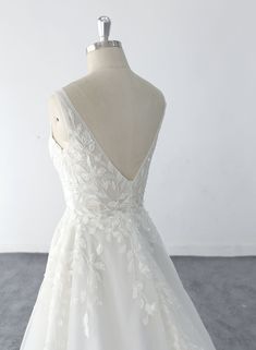 a white wedding dress on a mannequin