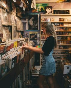 a woman looking at records in a record store on her instagram page, with the caption instagram