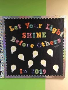 a bulletin board that says let your light shine together in front of a green wall