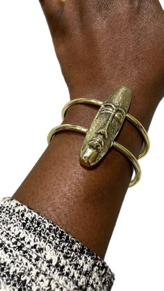 Embrace the heritage and artistry with the African Mask Brass Bracelet This striking piece, handcrafted from genuine brass, features a bold, intricately detailed mask design that evokes the rich cultural symbolism of African art. Short Face, African Inspired Jewelry, Long Face, African Mask, Brass Bracelet, African Masks, Jewelry Lookbook, African Jewelry, African Inspired