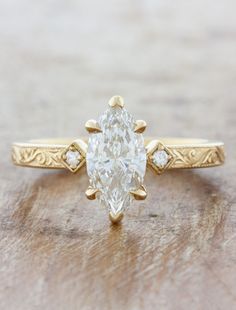 a yellow gold engagement ring with an oval cut diamond