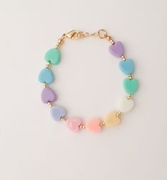 "If you would like to add gold filled hardware to a bracelet, please use this link to purchase it along with the bracelet. You will need to purchase one for EACH bracelet you would like to add gold filled hardware to. https://www.etsy.com/LittleLovliesShop/listing/860546443/gold-filled-upgrade?utm_source=Copy&utm_medium=ListingManager&utm_campaign=Share&utm_term=so.lmsm&share_time=1598757365437 Rainbow Heart Bracelet. These colorful pastel beads are aligned in a rainbow pattern a Handmade Pastel Bracelets For Gift, Everyday Multicolor Jewelry With Heart Charm, Mother's Day Bracelets With Heart Beads, Cute Adjustable Charm Bracelet With Heart Charm, Cute Nickel-free Bracelets For Birthday, Adjustable Heart Beads Bracelet For Birthday, Playful Bracelets With Heart Charm For Gift, Playful Bracelet With Heart Charm For Gifts, Cute Nickel-free Friendship Bracelets