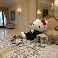 a hello kitty stuffed animal sitting on top of a pile of money in a living room