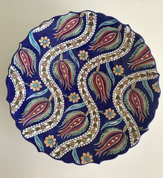 a blue plate with colorful designs on it