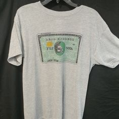 Gray American Express Grateful Dead Shakedown Lot Tee Reprint/Original 100% Dri-Wicking Cotton Feel Poly* Fully Sublimated Graphic To Provide "Zero Hand" To The Graphics And Verbiage Original Reprint (Original Had Stealie) *Also Available In Poly/Cotton Blend Please Reach Out Prior To Purchase Vintage Gray Summer T-shirt, Retro Gray Graphic Print Top, Retro Gray Top With Graphic Print, Retro Gray Short Sleeve Top, Vintage Gray T-shirt With Text Print, 90s Gray Graphic Print Top, 90s Style Gray Graphic Print Top, Vintage Printed Tops For Streetwear, Retro Gray T-shirt With Screen Print